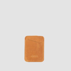 Vibrant orange leather card holder with capacity for 8 credit cards, ideal for the stylish minimalist