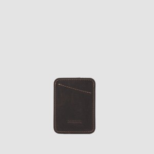 Dark brown minimalist card holder crafted from premium leather, holds 8 cards comfortably