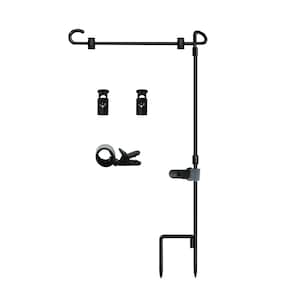 May include: Black metal garden flag stand with a hook and two clips. The stand has a pointed base for inserting into the ground.
