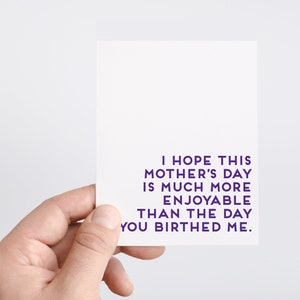 May include: A white card with purple text that reads "I hope this Mother's Day is much more enjoyable than the day you birthed me."