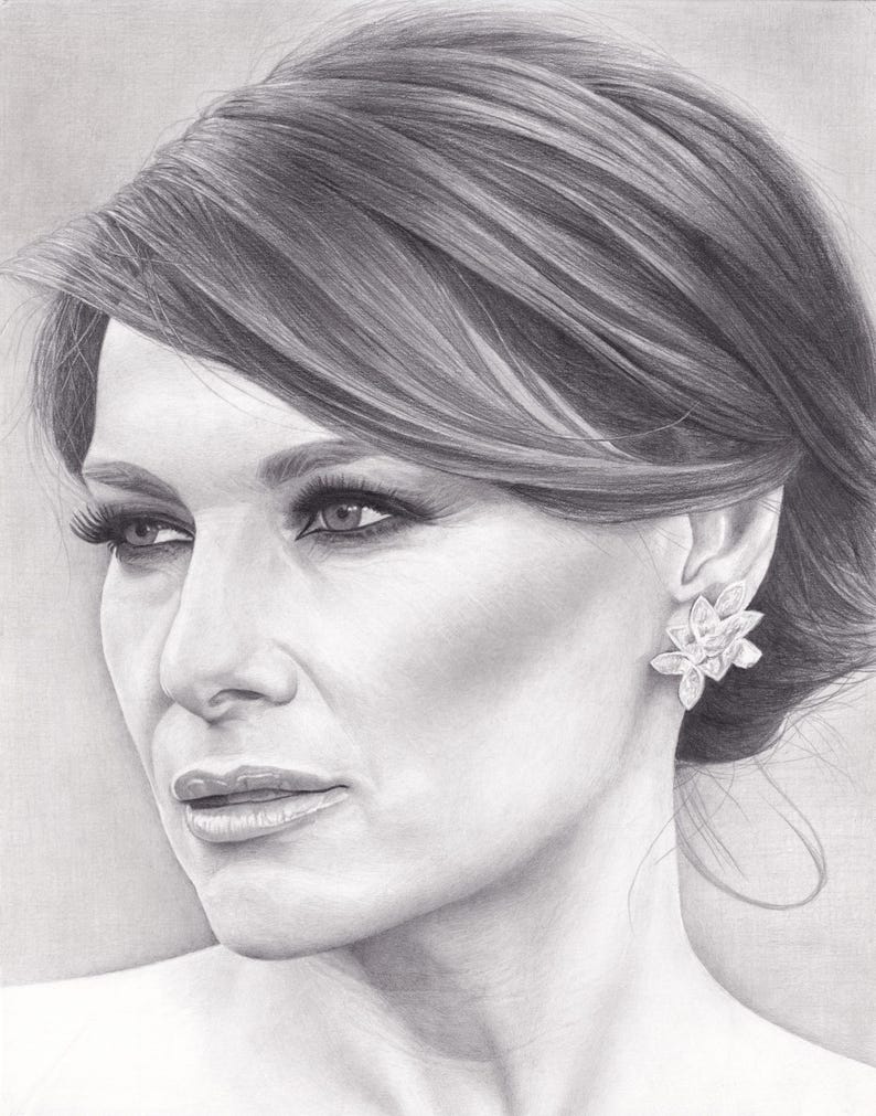 May include: A graphite pencil drawing of a person with hair styled in a side-swept updo. The subject is shown in a three-quarter profile view, wearing a large, multi-petaled floral-shaped earring on the visible ear, rendered in shades of gray.