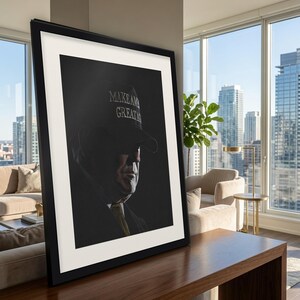 May include: A framed portrait print featuring a side profile of a person wearing a dark cap with the text MAKE AMERICA GREAT AGAIN in white lettering. The image uses high-contrast lighting, casting deep shadows across the face and neck.