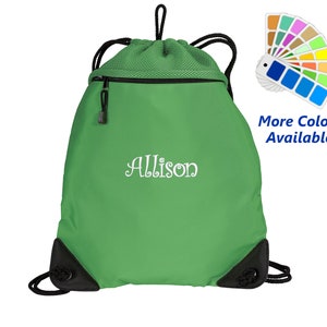 May include: Green drawstring bag with a black zipper and black drawstring. The bag has a white embroidered name "Allison" on the front. The bag is shown against a white background. More colors are available.