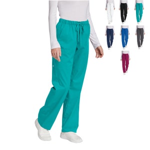 May include: A teal scrub pant with a drawstring waist and side pockets. The pant is worn by a person with a white shirt.