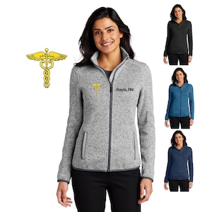 May include: A heather gray fleece jacket with a zipper closure. The jacket has a  medical symbol and the text "Kayla, RN" embroidered on the left chest. The jacket is shown on a model wearing black pants.