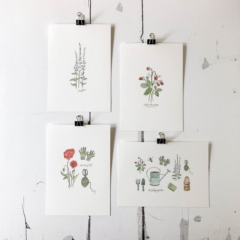 May include: Set of four botanical illustrations featuring a wild strawberry, a poppy, a sprig of forget-me-nots, and a sprig of  'into the wild' text. The illustrations are printed on white card stock and are perfect for framing.