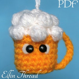May include: A crocheted beer mug with a white foam top and googly eyes. The mug is orange and has a handle. The text "PDF" is in the upper right corner of the image. The text "Elfin Thread" is in the lower left corner of the image.