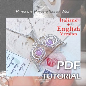 May include: A silver wire pendant in the shape of a mermaid tail with two pink gemstones. The pendant is on a silver chain and is labeled "Fili d'Argento". The image is for a PDF tutorial in Italian and English for making the pendant.