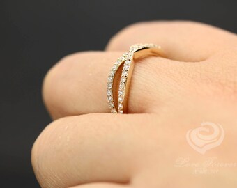 May include: A gold band ring with a delicate, intertwined design. The ring is set with small, sparkling diamonds.