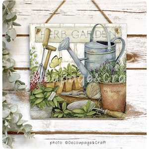May include: A watercolour painting of a herb garden with a watering can, gardening tools, and potted herbs. The sign above the scene reads "Herb Garden".