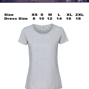 Pode incluir: Uma camiseta cinza claro com gola redonda. A imagem inclui uma tabela de tamanhos com tamanhos XS a 2XL, correspondentes aos tamanhos de vestido 8 a 18. O texto "Size Chart" est&aacute; no topo.