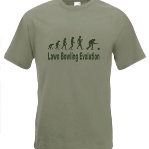 May include: A green t-shirt with a graphic of the evolution of humans ending with a person bowling. The text "Lawn Bowling Evolution" is printed below the graphic.