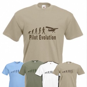 May include: Four t-shirts with a graphic of the evolution of a pilot, starting with a caveman and ending with a pilot flying a small plane. The text "Pilot Evolution" is printed below the graphic. The t-shirts are in four different colors: light blue, khaki, white, and dark green.