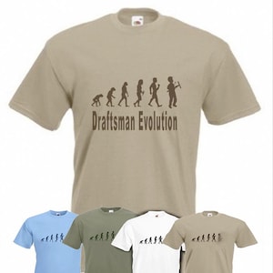 May include: A beige t-shirt with a brown graphic of the evolution of a draftsman. The graphic shows a series of stick figures progressing from a primitive ape to a modern draftsman holding a T-square. The text "Draftsman Evolution" is printed below the graphic.