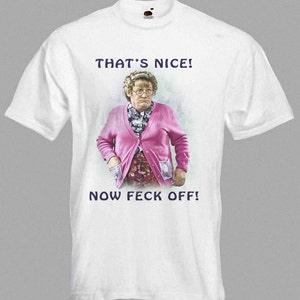 May include: White t-shirt featuring a cartoon image of a woman wearing a pink cardigan and the text "That's Nice! Now Feck Off!"