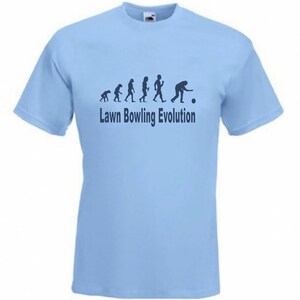 May include: A light blue t-shirt with a graphic of the evolution of humans ending with a person bowling. The text "Lawn Bowling Evolution" is printed below the graphic.