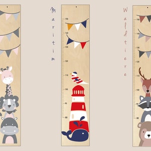 May include: Three wooden growth charts with different themes: Safari, Maritime, and Woodland. Each chart features a colorful animal illustration and a measuring scale in inches. The Safari chart has a giraffe, lion, and hippopotamus. The Maritime chart has a lighthouse, a seagull, and a whale. The Woodland chart has a deer, a raccoon, and a bear.