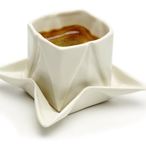 Origami espresso cup made of porcelain including saucer, with folds and kinks like folded paper
