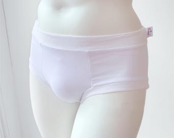 May include: Solid white briefs featuring a wide, elasticized waistband and a small, rectangular fabric tag on the right side. The tag displays a colorful, stylized rainbow graphic above the text "SPR" in bold, dark blue, capital letters.