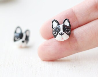 May include: A pair of black and white French bulldog earrings made of polymer clay.