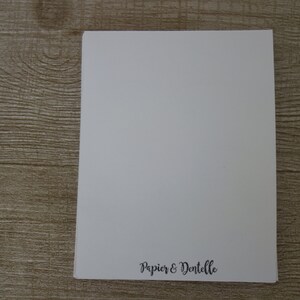 May include: A blank white card with the text "Papier & Dentelle" printed in black at the bottom.