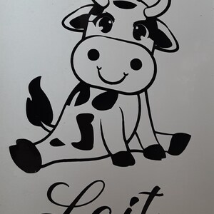May include: Black and white cartoon illustration of a cow with big eyes and a smile. The cow is sitting down with its legs crossed. The word "Lait" is written in cursive below the cow.