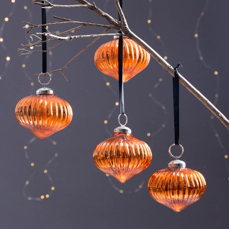 Burnt amber orange glass baubles in onion shape with silver accents. These elegant Xmas baubles are high-quality handmade beautiful Xmas decorations.