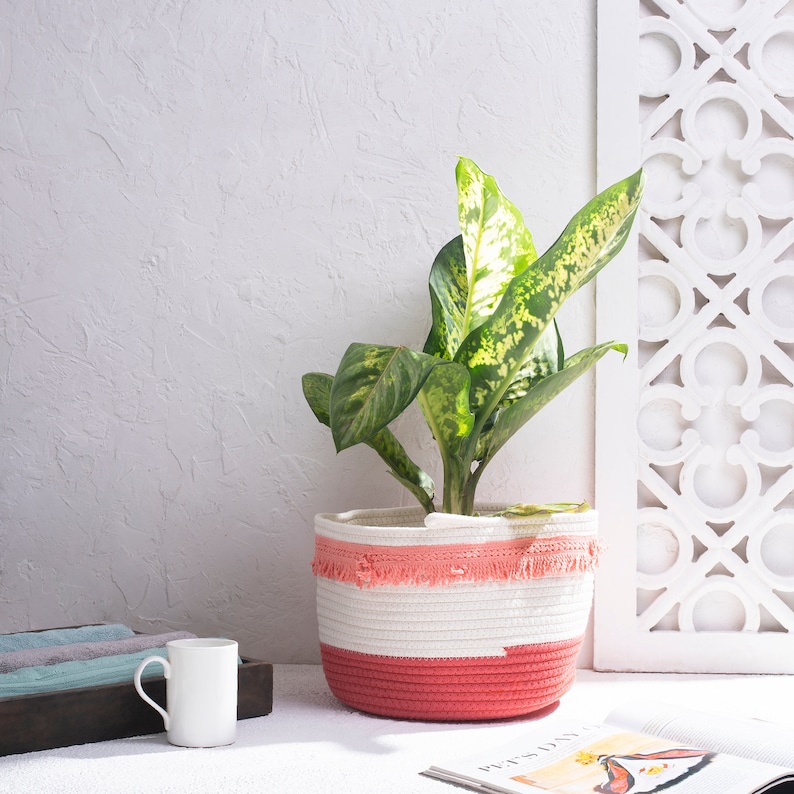 Pink and white cotton basket super soft washable basket ideal for storage of toys, clothes, craft materials, wool. Modern and contemporary in bright feminine colours with tassels around the upper edge. Handmade available in two sizes