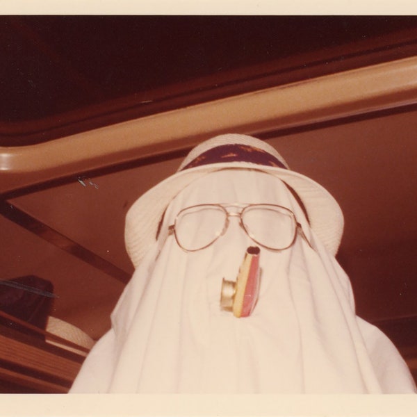 FUNNY 1970s color photograph masked hooded COSTUME man with fishing hat and KAZOO vintage snapshot surreal string vernacular photo