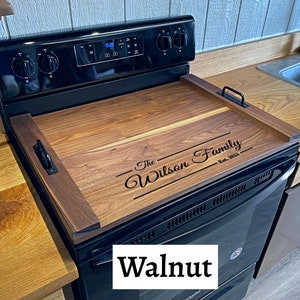 Full Size Dark Walnut Stovetop cover sitting on Range with a last name engraving