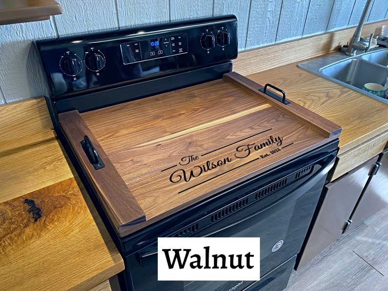Full Size Dark Walnut Stovetop cover sitting on Range with a last name engraving
