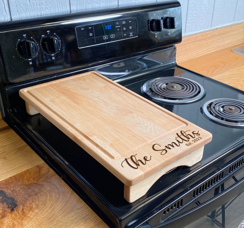 Half Size Maple cover sitting on a range with an engraving on the lower half of it.