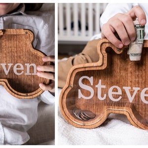 Wooden Tractor Shaped Piggy Banks with Personalized Engraving on the Clear Front, With Child Holding Personalized Bank
USA Red Oak Wood, This wood Gives The Bank A Natural Red/ Brown Look