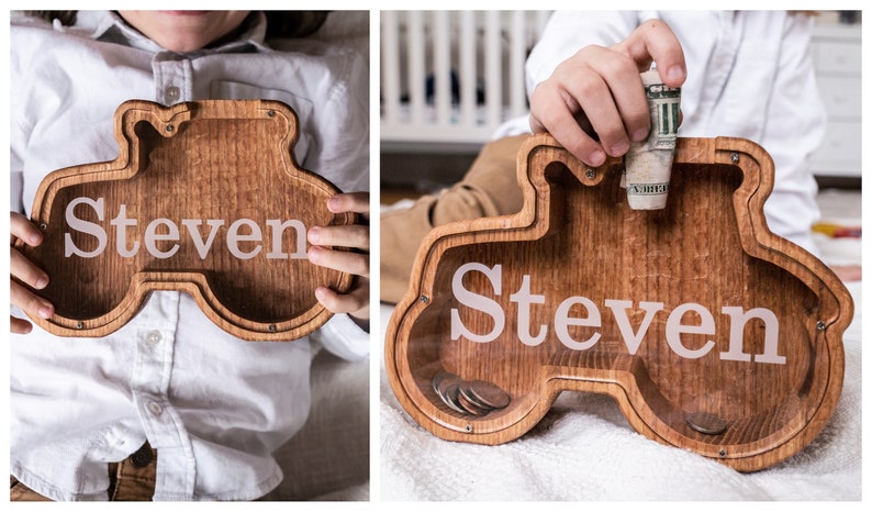 Wooden Tractor Shaped Piggy Banks with Personalized Engraving on the Clear Front, With Child Holding Personalized Bank
USA Red Oak Wood, This wood Gives The Bank A Natural Red/ Brown Look