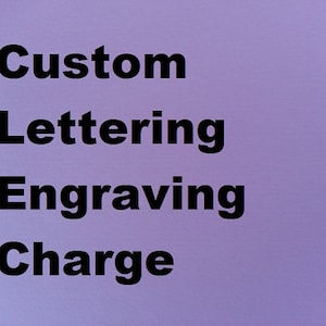 May include: Custom lettering engraving charge written in black text on a purple background.