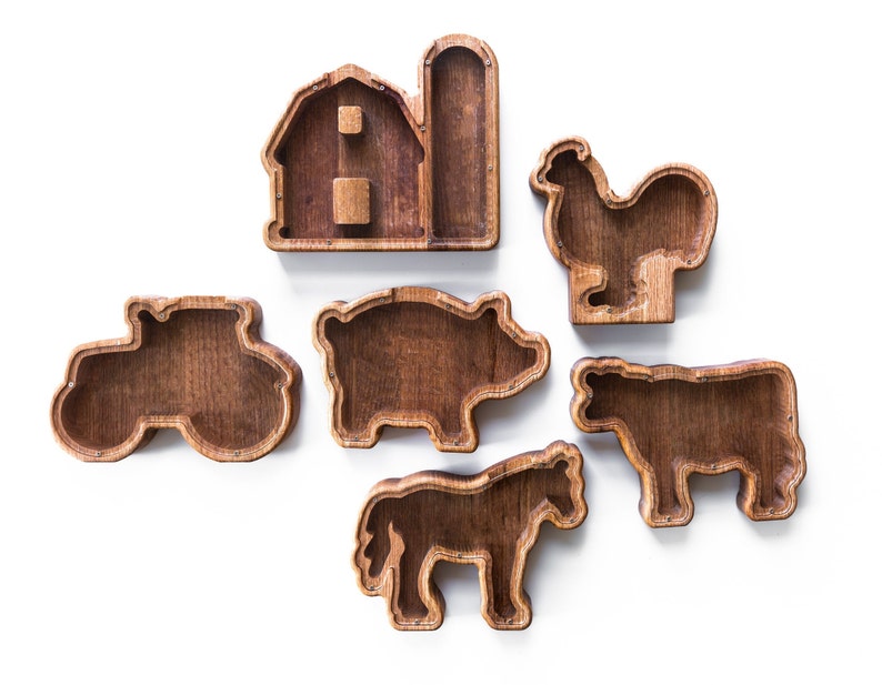 May include: Wooden farm animal shapes with a barn and tractor. The shapes are hollow and can be used as storage containers.