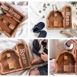 Wooden Barn Shaped Piggy Banks with Personalized Engraving on the Clear Front With White Background And Child Placing Dollar Bill In Bank
USA Red Oak Wood, This wood Gives The Bank A Natural Red/ Brown Look