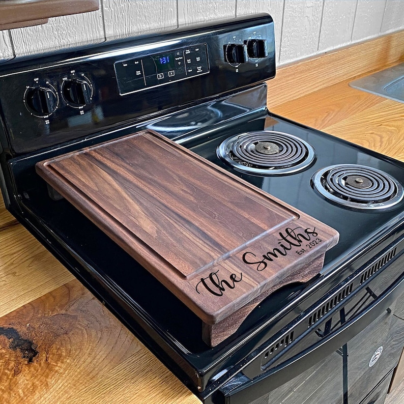 Half Size Walnut cover sitting on a range with an engraving on the lower half of it.