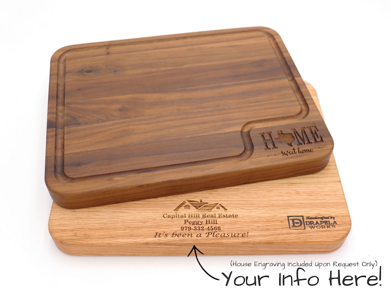 May include: Two wooden cutting boards, one with a Texas-shaped cutout and the text "HOME sweet home" engraved, and the other with a house design and the text "Capital Hill Real Estate Peggy Hill 979-332-4566 It's been a Pleasure!" engraved. The bottom board also has the text "Handcrafted by DRAPELA WORKS" engraved.