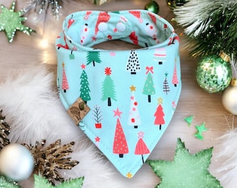 May include: A light blue bandana with a Christmas tree pattern. The trees are red, green, and white with gold stars. The bandana has two white snaps on the back.
