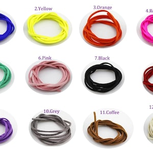 May include: Twelve spools of suede cord in various colours, including blue, yellow, orange, red, green, pink, black, white, purple, grey, brown, and white. Each spool is labelled with a number and colour name.
