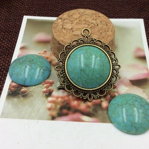May include: Three turquoise cabochons, one with an ornate bronze frame, ready for jewellery making.