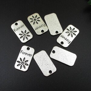 10 dijes de flores eternas de 14 x 24 mm, etiquetas metálicas rectangulares plateadas - p1282