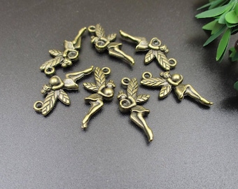 May include: A set of eight bronze-colored metal charms featuring fairy figures with wings and holding a heart. The charms are perfect for jewelry making or scrapbooking.