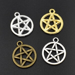 May include: Four silver, gold, and bronze charms with a pentagram design. The charms are round and have a loop at the top for attaching to a necklace or bracelet.