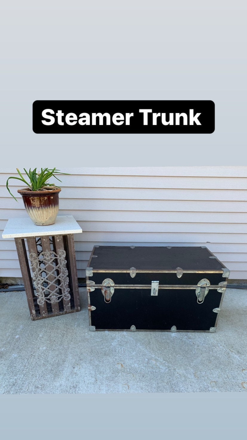 Sold at Auction: Vintage Steamer Trunk - material covered with timber slats  and steel strapping with black painted finish, leather handles with brass  latch, paper lined interior. Height 49cm x 91cm wide
