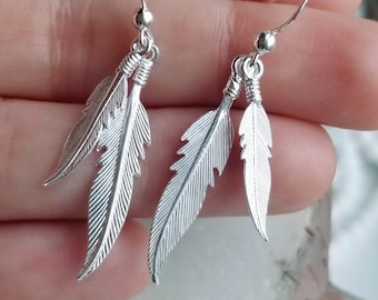 Metallic silver bullet necklace and painted feather earrings