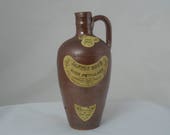 Stoneware wine bottle. Portuguese rustic salt glazed stoneware wine bottle with original 1960s labels