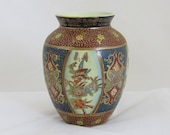 Chinese pottery vase Beaded porcelain vase with elaborately decorated and gilded panels in white and blue between red bands