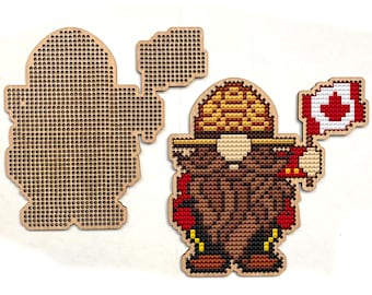 May include: Wooden craft kit featuring a gnome holding a Canadian flag. The gnome is wearing a brown hat and has a brown beard. The kit includes a pre-cut wooden base and all the necessary materials to complete the project.